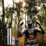 Man in a forest with a backpack, flexing his muscles, and water bottles displayed.