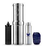 A stainless steel Phoenix Gravity Mini water filter with a black activated carbon cartridge, a silver bottle, and a blue carrying pouch emergency water filter.